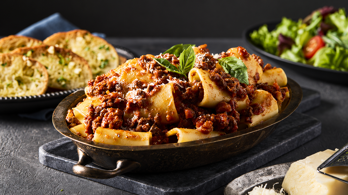 Fillet Steak Mince served in a rich pasta dish with garlic bread and salad